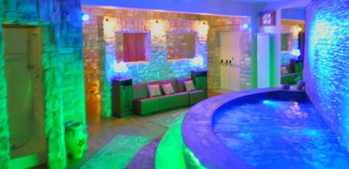 - une salle de bains avec baignoire dans une chambre éclairée dans l'établissement Hotel Miramonti, à Gambarie dʼAspromonte