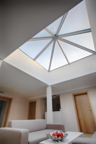 a skylight in a living room with a glass ceiling at Executive Rooms and Suites Play in Veliko Tŭrnovo