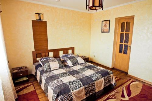 a bedroom with a bed with two pillows on it at Filvarok Hotel in Brody