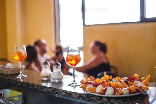 a table with a plate of food and glasses of wine at Hotel Firenze 2000 in Florence