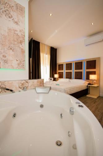 a large bathroom with a bath tub and two beds at Vatican Relais Rome Suite in Rome
