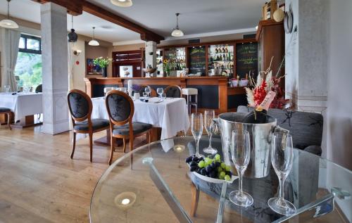 a dining room with a glass table and chairs at Romantic Hotel Mlýn Karlstejn in Karlštejn