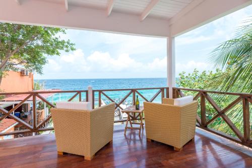 a balcony with a view of the ocean at Scuba Lodge & Suites in Willemstad