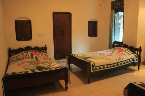 Cama o camas de una habitación en Sunarta House Homestay