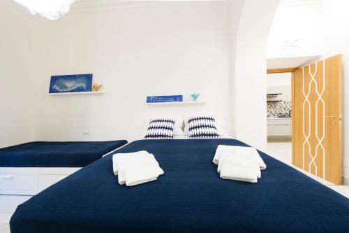 a bedroom with a blue bed with two pillows at Ottaviano Exclusive Maison in Rome