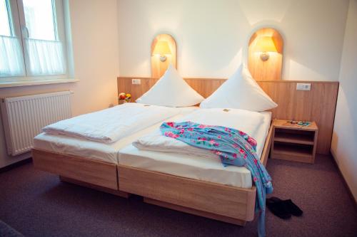 a bedroom with a bed with a blanket on it at Seepark Wolfswinkel in Storkow