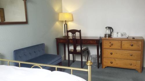 a bedroom with a desk and a chair and a table at Shearwater in Bridlington