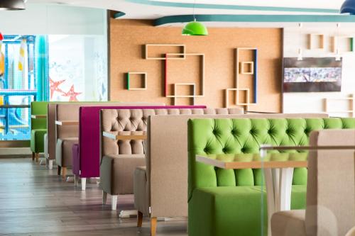 a green room filled with lots of green chairs at Hotel Riviera in Mamaia