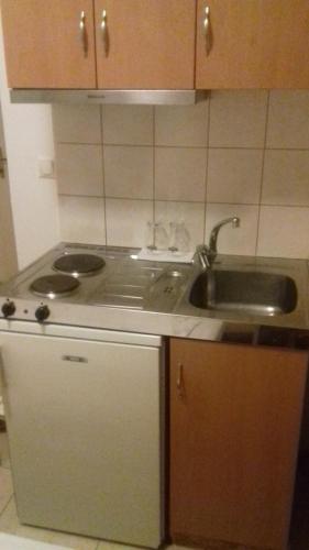 a kitchen with a sink and a counter top at Studios Kapsalas in Néa Michanióna