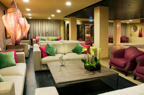 a lobby with couches and chairs and a table at Kn Hotel Arenas del Mar Adults Only in El Médano