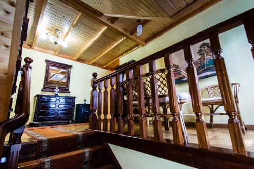 a room with a wooden staircase and a bed at Casal de Cereixo in Tufiones
