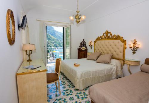 Postel nebo postele na pokoji v ubytování Hotel Reginella