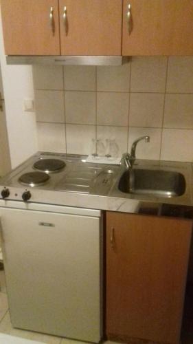 a kitchen with a sink and a counter top at Studios Kapsalas in Néa Michanióna