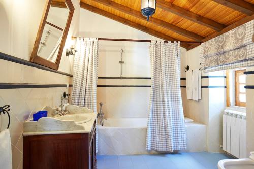 a bathroom with a tub and a sink and a bath tub at Casa D Obidos in Óbidos