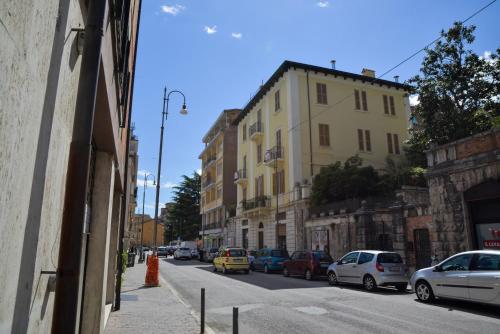 a city street with cars parked on the side of the road at Casa Malena in Ascoli Piceno