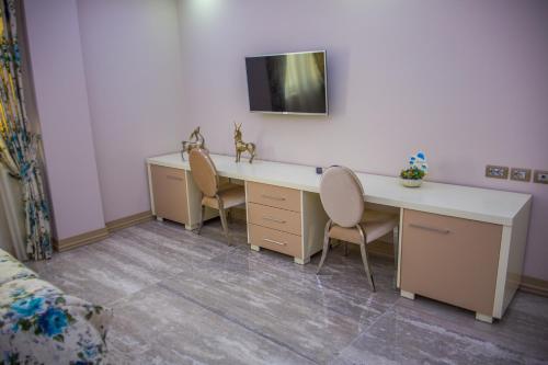 a room with a desk and two chairs at Hotel Vila Koral in Durrës