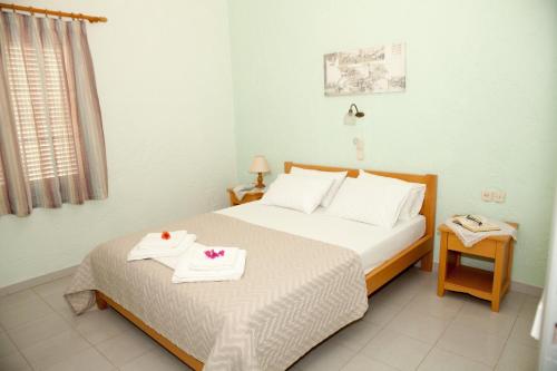 a bedroom with a bed with two towels on it at Liviko View in Xerokampos