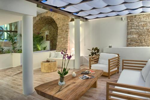 a living room with a table and a couch at El Petit Convent in Begur
