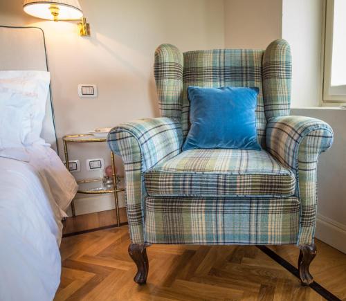 a blue pillow in a chair in a bedroom at Castello Di Mornico Losana in Mornico Losana