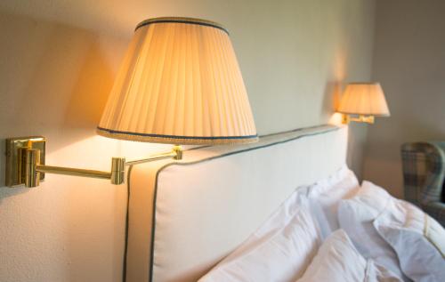 a bedroom with a bed with a lamp on it at Castello Di Mornico Losana in Mornico Losana