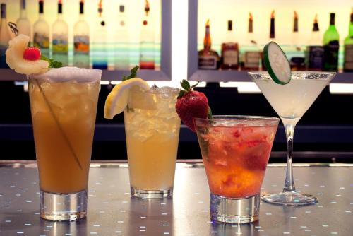 a group of four cocktails sitting on a table at Aloft El Segundo - Los Angeles Airport in El Segundo