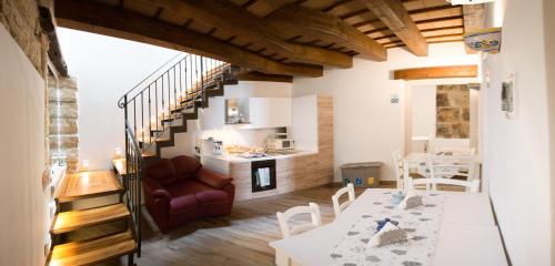 a living room with a dining table and a kitchen at B&B Cinisi Vacanze 2.0 in Cinisi