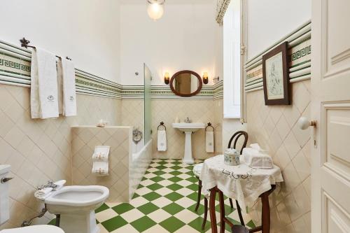 a bathroom with a toilet and a sink at Casa D Obidos in Óbidos
