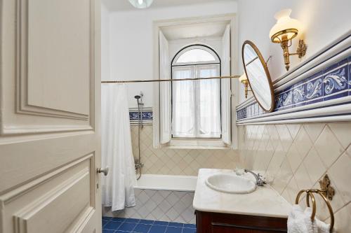 a bathroom with a sink and a mirror at Casa D Obidos in Óbidos