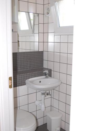 a bathroom with a sink and a toilet at CamperBase in Oksbøl