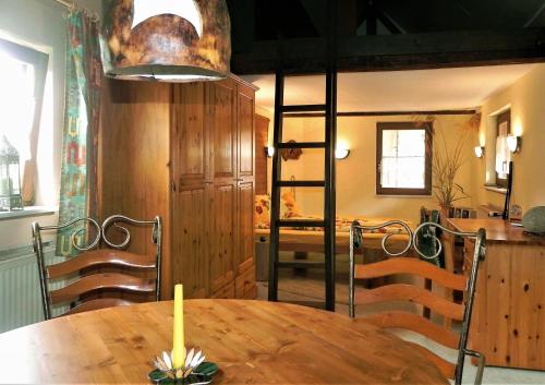 a dining room with a table with a candle on it at Ferienwohnung BogenTenne in Eußenheim