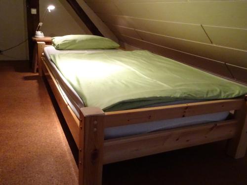 a small bed in a small room with at Ferienwohnung BogenTenne in Eußenheim