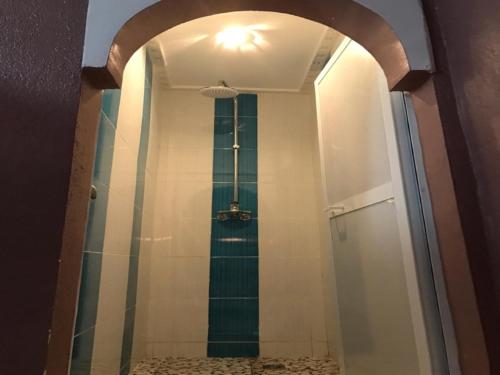 a bathroom with a shower with a glass door at Kasbah Red Castel Hostel in Marrakesh