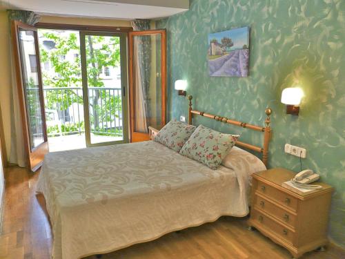 a bedroom with a bed and a phone on a table at Hotel Nice in La Seu d'Urgell