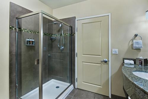 a bathroom with a shower and a sink at Oxford Suites Silverdale in Silverdale