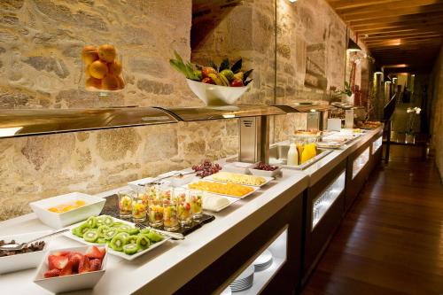 a buffet line with many plates of food at San Francisco Hotel Monumento in Santiago de Compostela