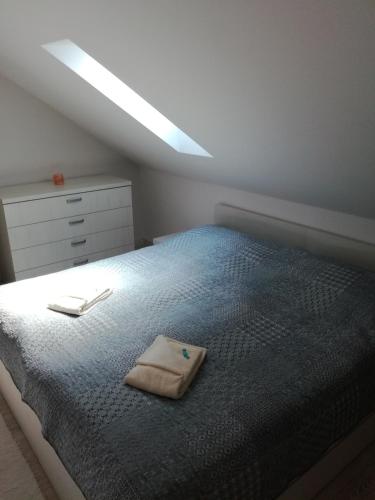 a bedroom with a bed with a towel on it at Apartmány Pelech in Trenčianske Teplice