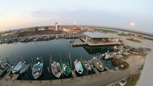 a group of boats are docked at a marina at Albergo Ristorante Uspa in Gorino Ferrarese