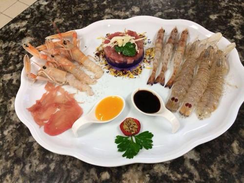a plate of food with seafood on a table at Albergo Ristorante Uspa in Gorino Ferrarese