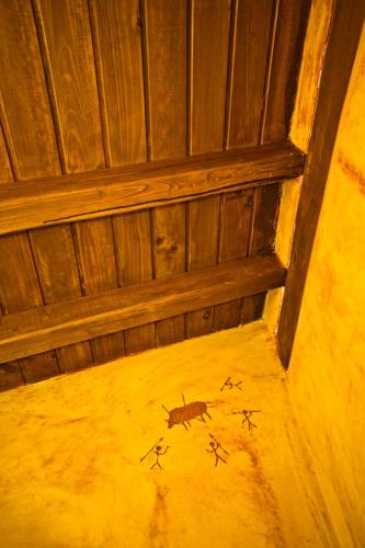 an attic room with a painting of a bug on the floor at Casa del Herrero in Mogarraz