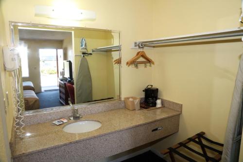 a bathroom with a sink and a mirror at Red Carpet Inn Oxford in Oxford