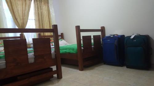 a bedroom with two bunk beds and two luggage at The Clover 20-28 in Palmira