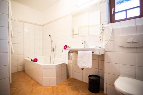 a bathroom with a tub and a sink and a toilet at Grafenberg Chalet in Wagrain