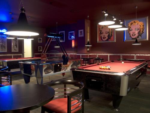 a bar with a pool table and ping pong tables at Hotel AquaCity Seasons in Poprad