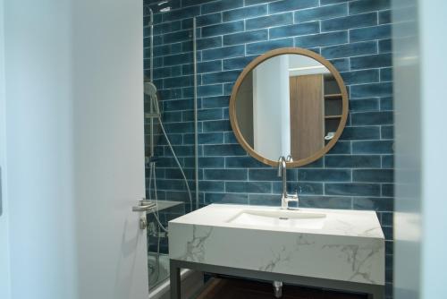 a bathroom with a sink and a mirror at Mandali Hotel in Protaras