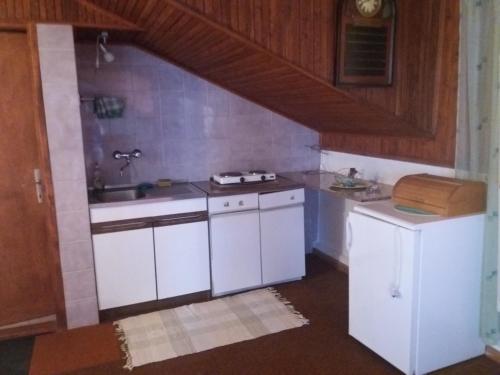 a kitchen with white cabinets and a sink at Apartman Amalija in Gornji Karin