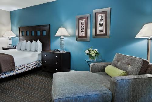 a hotel room with a bed and a couch at Oxford Suites Silverdale in Silverdale
