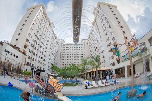 a view of a hotel with a swimming pool and buildings at Boulevard Suíte Hotel by WAM Experience in Caldas Novas