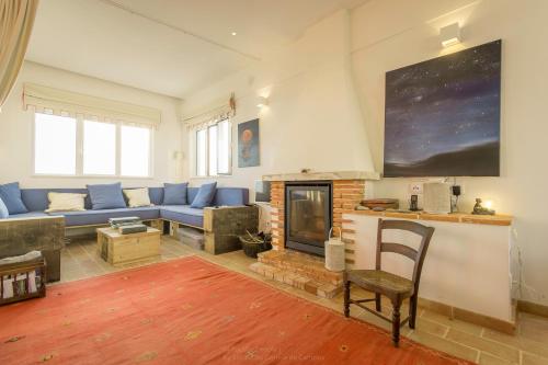 a living room with a couch and a fireplace at Magoito1 in Sintra