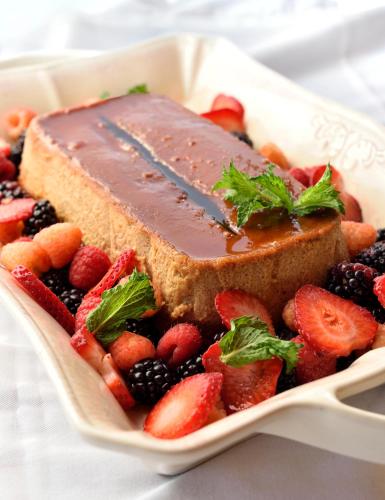 a piece of cake with strawberries and berries on a plate at Casa Culinaria - The Gourmet Inn in Santa Fe