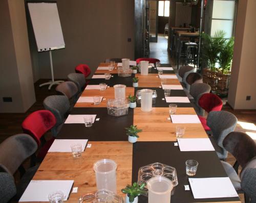 a conference room with a long table with chairs at alexxanders Hotel & Boardinghouse, Restaurant in Chemnitz